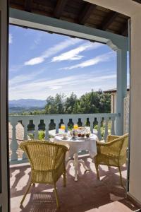 a patio with a table and chairs on a balcony at Hotel Palacio Urgoiti in Mungia +42 photos