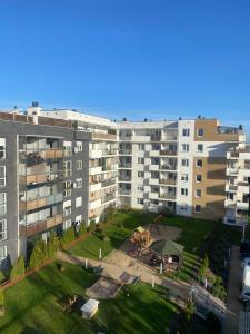 un immeuble d'appartements avec une pelouse devant lui dans l'établissement Apartament Rezydencja Metropolis ul.Dąbrowa 15, à Bydgoszcz