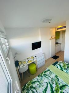 a bedroom with two beds and a desk and a tv at Studio 88 in Wrocław