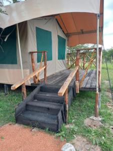 a tent with a staircase in front of it at Sonkoi Tent Safari Camp in Narok