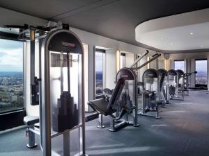 a gym with treadmills and ellipticals in a building at Sofitel Melbourne On Collins in Melbourne