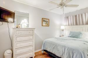 a bedroom with a bed and a dresser and a television at HH Beach & Tennis 246B in Hilton Head Island