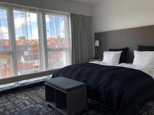 Postel nebo postele na pokoji v ubytování Hotel Skivehus
