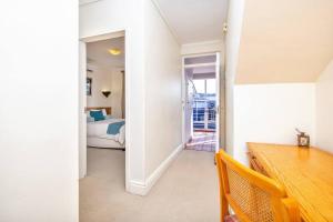 a room with a bedroom with a bed and a desk at Sheer Nest in Knysna