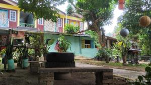 a tire sitting on a bench in front of a building at Tahan Guest House in Kuala Tahan