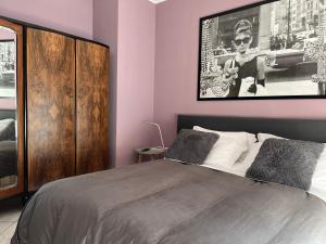a bedroom with a bed with a large picture on the wall at Via Roma suite in Ortona