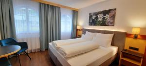 Postel nebo postele na pokoji v ubytování Hotel Garni Belvedere