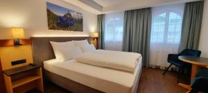 Postel nebo postele na pokoji v ubytování Hotel Garni Belvedere
