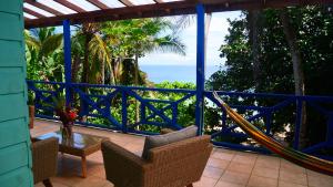 a porch with a hammock and a view of the ocean at Tesoro Escondido Ecolodge Cabinas in Bocas del Toro