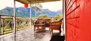 a porch with two chairs and a table with a view at The Wild Fo'rest Resorts in Masinagudi