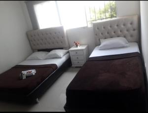 a bedroom with two beds and a window at buenavista class in Barranquilla