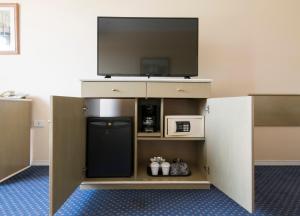 a room with a tv and a small refrigerator at Holiday Inn Cordoba, an IHG Hotel in Córdoba