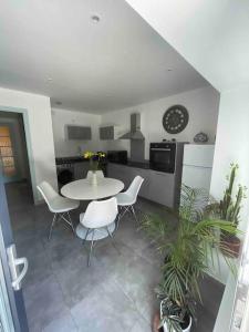 a kitchen with a table and chairs in a room at Au coeur des Alpes 3 in La Roche-sur-Foron