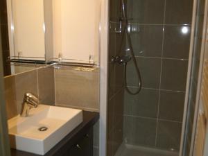 a bathroom with a sink and a shower at Appartement haut de gamme 3P cabine, pied des pistes, balcon, parking, centre station à 150m - FR-1-557-15 in Les Adrets +8 photos
