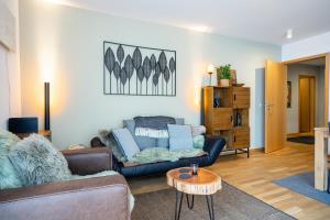 a living room with a couch and a table at Steinadler Monte - Skiing Holiday in Obertauern in Obertauern