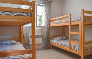 a bedroom with two bunk beds and a window at Cozy Home In Moriani Plage With Wifi in Moriani Plage
