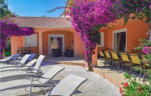 モリアニ・プラージュにあるBeautiful Home In Moriani Plage With Outdoor Swimming Poolのパティオの椅子と紫の花