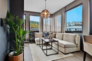 a living room with a couch and a table at Origo Leilighetshotell- Øvre Storgate 5 in Drammen