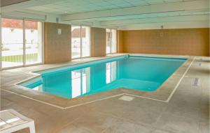 a large swimming pool in a large room at Lovely Home In Vaudoy-En-Brie With Wifi in Vaudoy-en-Brie