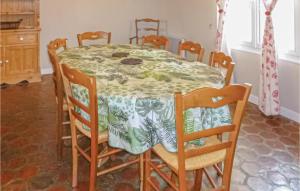 a dining room table with a green and white table cloth at Lovely Home In Vaudoy-En-Brie With Wifi in Vaudoy-en-Brie +16 photos