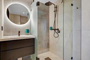 a bathroom with a shower and a sink at Origo Leilighetshotell- Øvre Storgate 5 in Drammen +21 photos