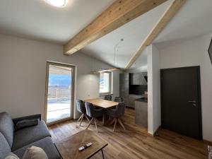 a living room and dining room with a table and chairs at Appart Anna in Scheffau am Wilden Kaiser