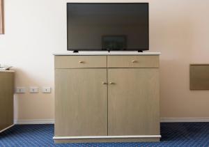 a flat screen tv on top of a cabinet at Holiday Inn Cordoba, an IHG Hotel in Córdoba