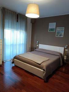 Postel nebo postele na pokoji v ubytování B&B Giulio Cesare + 14 fotografií