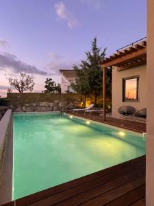 a swimming pool in the middle of a house at Dimeli - Sea View Villas in Foinikounta in Finikounta