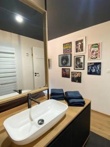 a bathroom with a white sink and a mirror at Maison de vacances la Grange 20 min de namur 