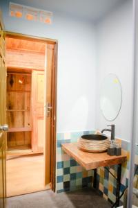 a bathroom with a counter with a mirror and a sink at Anstay Homestay & Apartment in Da Nang