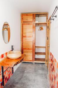 a bathroom with a wooden door and a sink at Anstay Homestay & Apartment in Da Nang
