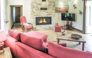 a living room with a couch and a fireplace at Nice Home In Fleurac With 3 Bedrooms, Outdoor Swimming Pool And Swimming Pool in Fleurac