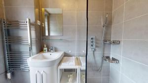 a small bathroom with a sink and a shower at La maison Blanche - Issenheim in Issenheim +26 photos