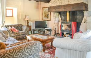 a living room with couches and a fireplace at Cozy Home In Montaut With Outdoor Swimming Pool in Montaut