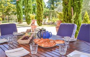 a table with a plate of bread and pastries on it at Cozy Home In Montaut With Outdoor Swimming Pool in Montaut