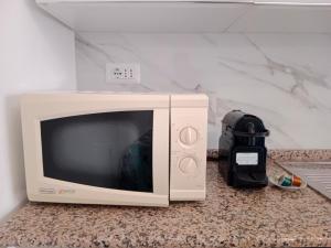 TV a/nebo společenská místnost v ubytování San Pietro Holiday Apartment