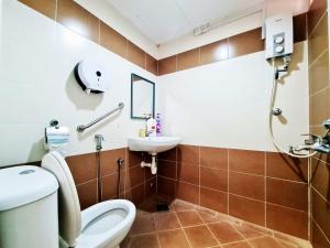 a bathroom with a toilet and a sink at MG Mutiara Gurney in George Town