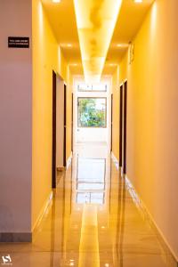 an empty hallway with yellow walls and a window at Dibrugarh Tea Residency in Dibrugarh