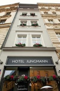 a building with flowers in the windows of a hotel istg at Jungmann Hotel in Prague