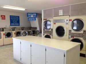 a laundry room with washing machines and a counter at Chaparral Inn in Arcola