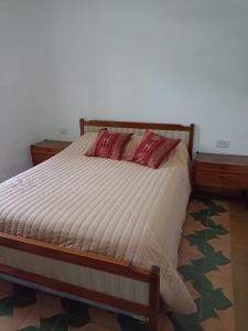 a bed in a room with two nightstands and a bed sidx sidx sidx at Inti Raymi in Maimará