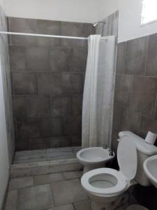 a bathroom with a toilet and a shower at Inti Raymi in Maimará