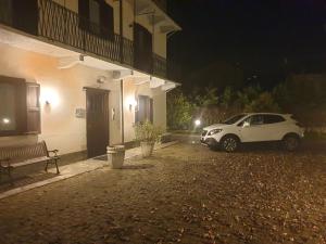 a white car parked next to a building at night at Hotel Isolabella in Bussoleno