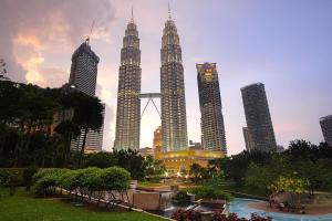 a group of tall skyscrapers in a city at 3 Towers Klcc By Tenang Homes in Kuala Lumpur