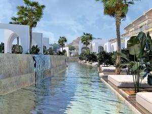 a water feature in a resort with palm trees and buildings at Kolymbia Bay Art Boutique Hotel - Adults Only in Kolimbia