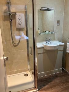 a bathroom with a shower and a sink at Eagle Hotel in Dornoch