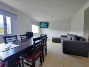 a living room with a table and a couch at COMPLEJO LA CASCADA ESQUEL in Esquel