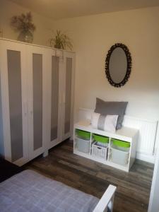 a room with a white cabinet and a mirror at Albany Rooms in Bexley