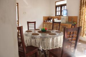 a table with a bowl of fruit on it in a kitchen at Holiday Home Anuradapura in Anuradhapura